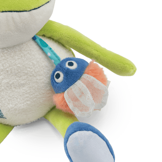 Close-up of embroidered mushroom accessory on plush frog strap