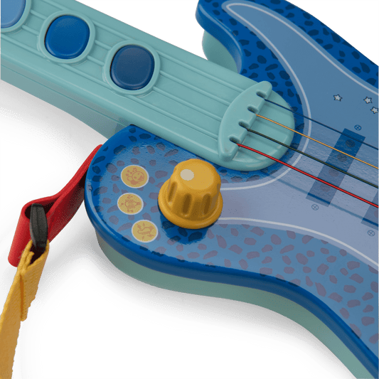 Dark blue spotted toy guitar body with yellow knob and character stickers