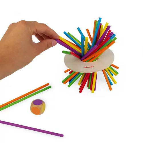 Janod Crazy Sticks game hand removing purple stick from wooden base