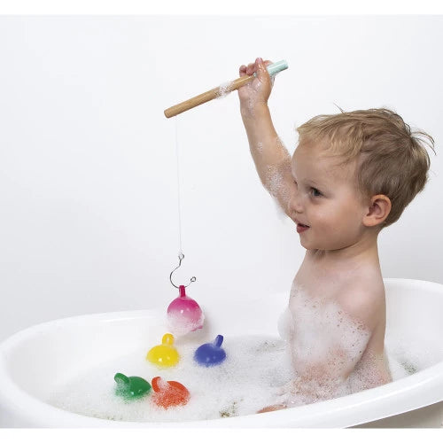 Toddler playing with JANOD octopus fishing game in bathtub soapy water