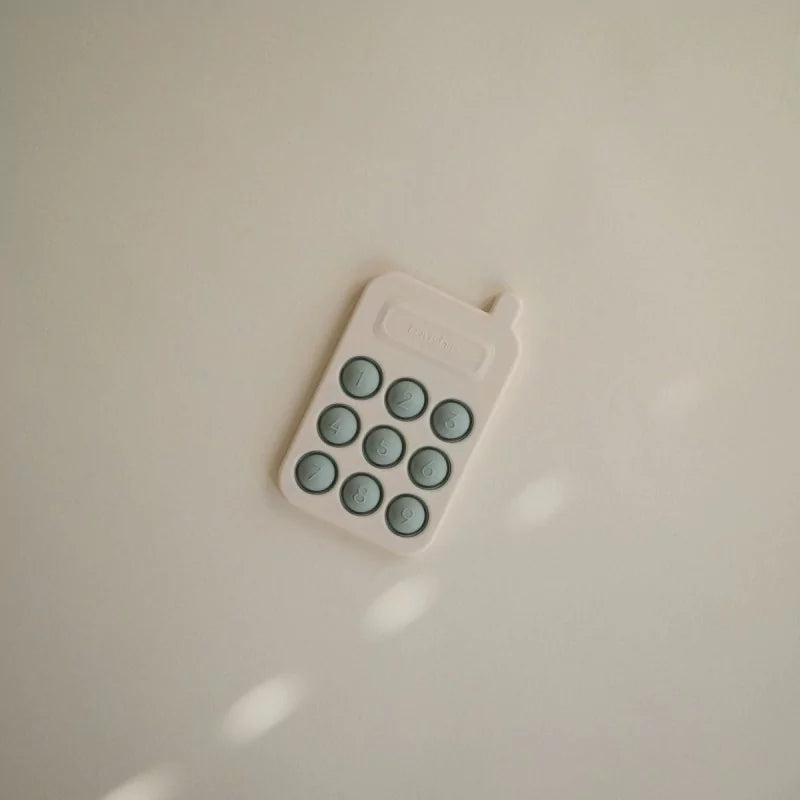 MUSHIES Cambridge Blue silicone press-toy phone with sage green buttons