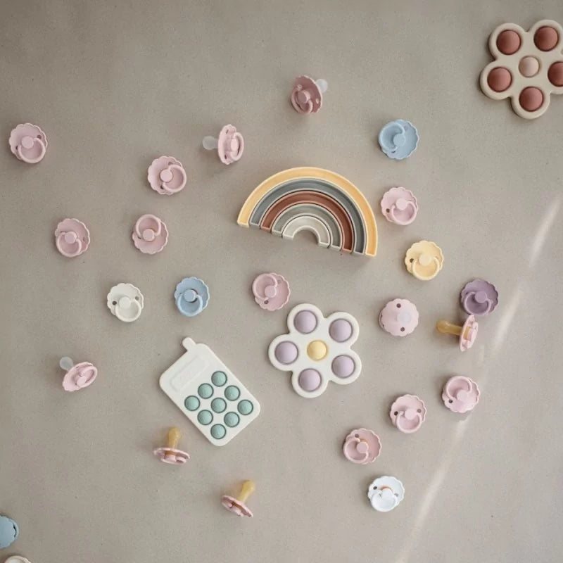 MUSHIES sensory toy collection featuring silicone phone and pacifiers