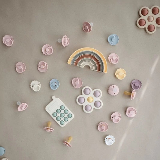 MUSHIES sensory toy collection featuring silicone phone and pacifiers