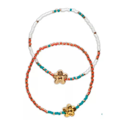 Layered orange white and teal beaded bracelets with flower charm