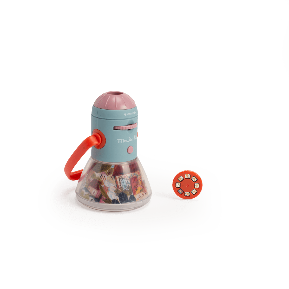 Teal and pink Moulin Roty story lantern next to orange projection disc on white background