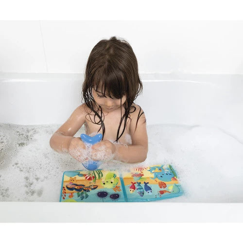 Child using blue fish gusher with underwater bath book