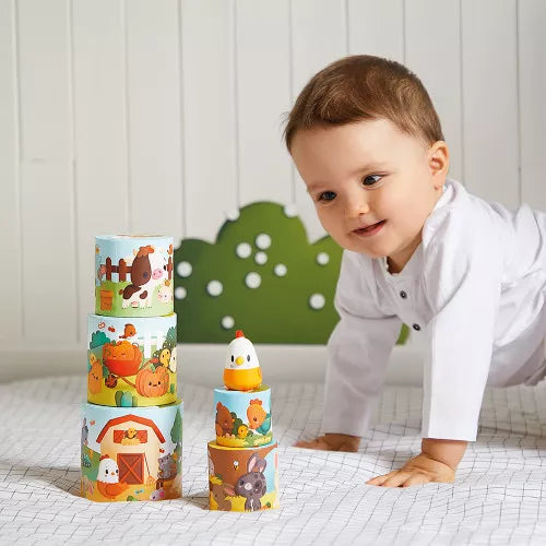 Toddler playing with wooden farm animal stacking pyramid toy