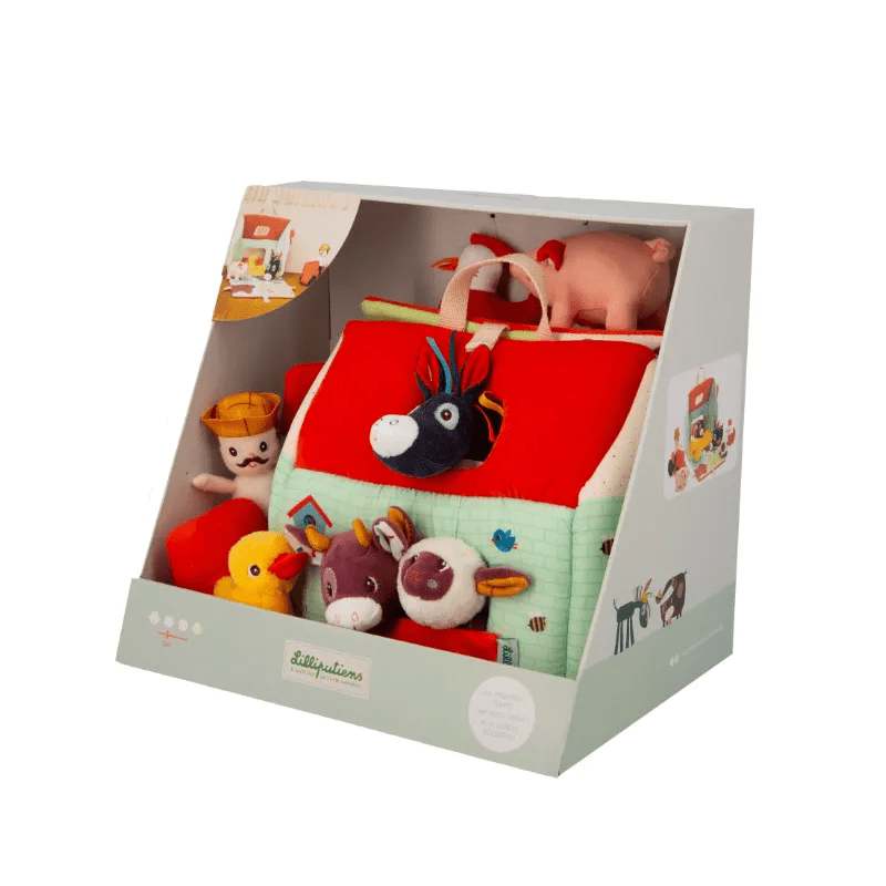 Lilliputiens Ma première ferme open box display showing folded farm toy and plush figures