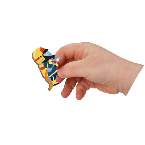 Close-up of child holding colorful firefighter magnet figure from JANOD set
