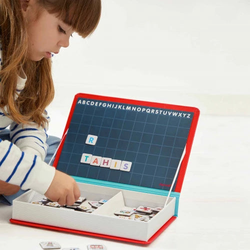 Child playing with red book-shaped French alphabet magnetic tile game set