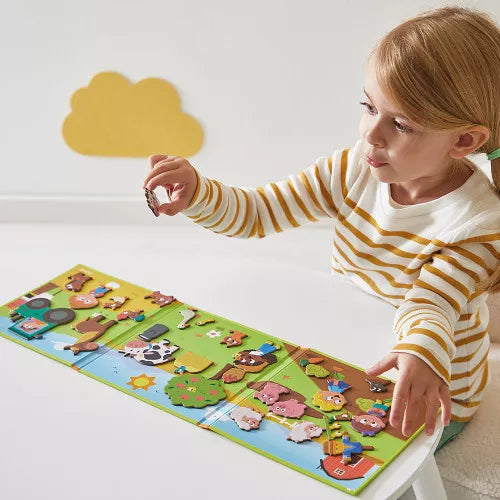 Toddler girl playing with JANOD magnetic farm story set