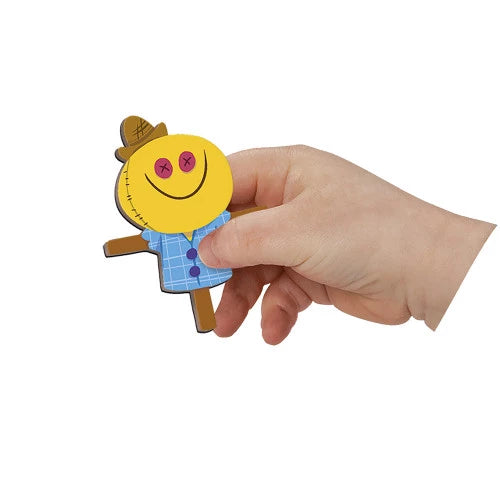 Close-up yellow scarecrow magnetic piece with plaid shirt and button eyes held by child hand