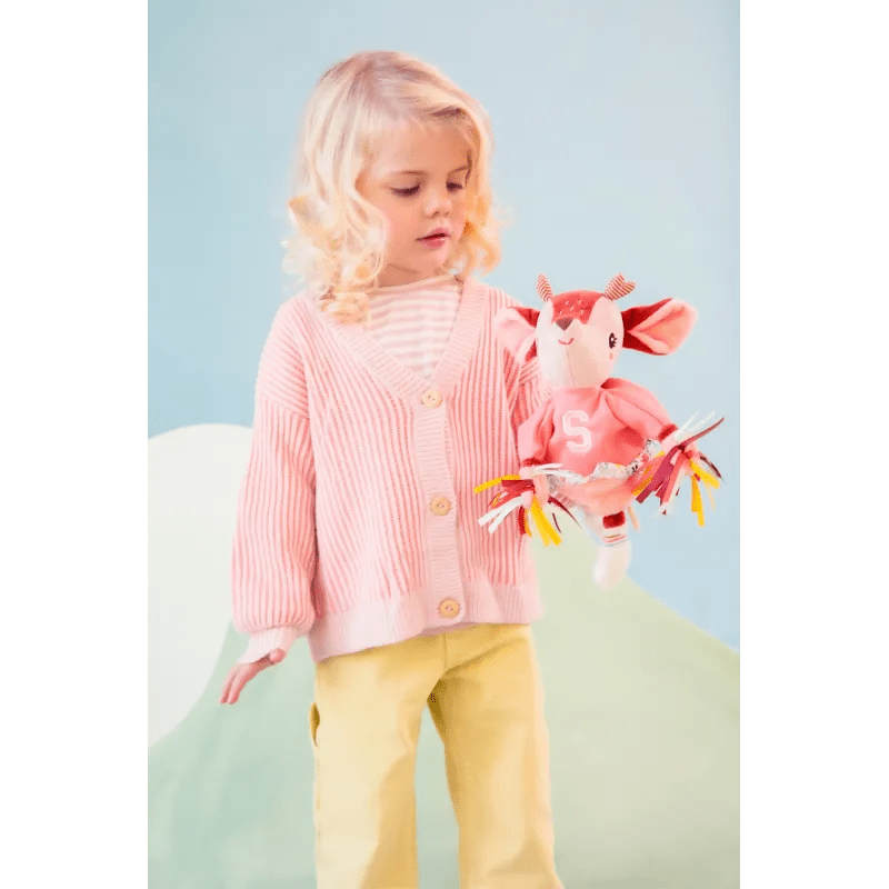 Child playing with Stella plush deer hand puppet holding pom-poms