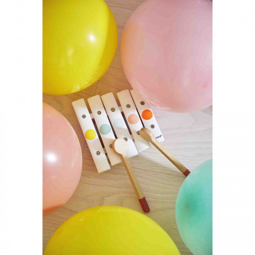 Colorful JANOD wooden xylophone on floor with balloons for children's musical play