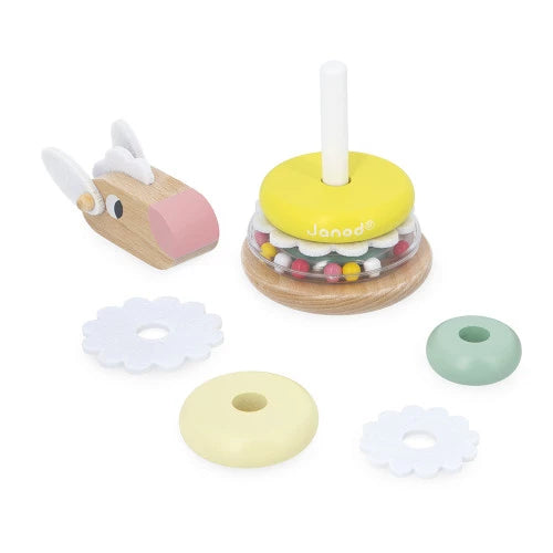 Disassembled parts of Janod wooden sheep stacking toy including rings and base peg
