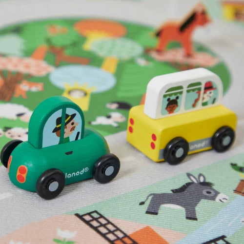 Green Janod wooden car on farm play mat with character driver