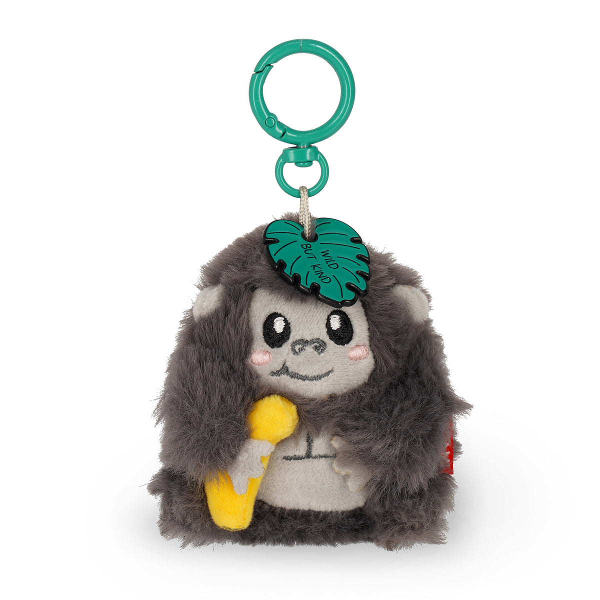 Grey plush gorilla keychain holding banana with "Wild But Kind" leaf charm
