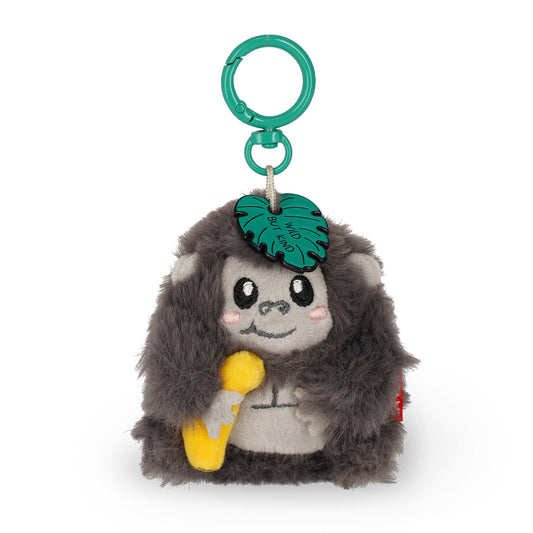 Grey plush gorilla keychain holding banana with "Wild But Kind" leaf charm