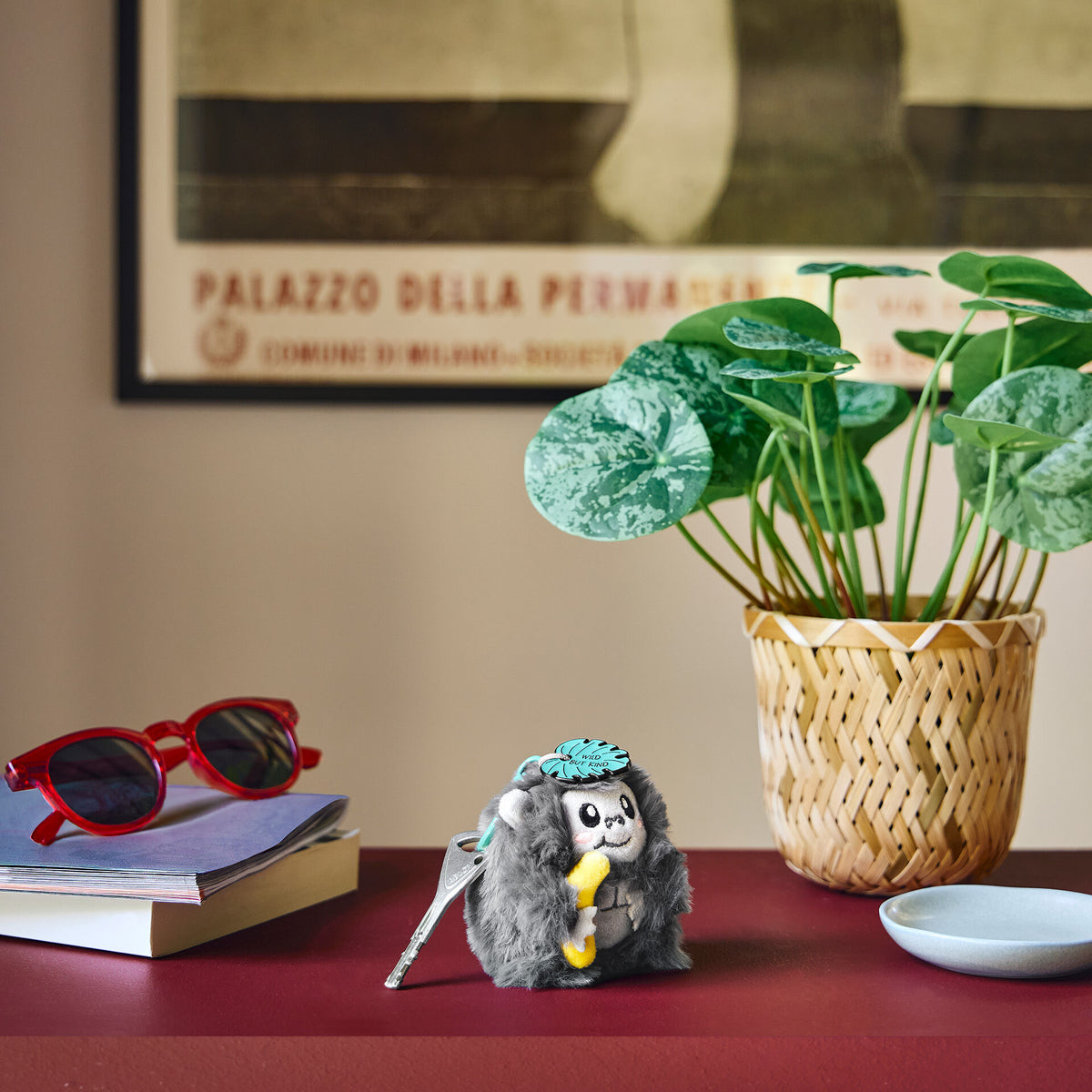 Gorilla plush keychain attached to keys in lifestyle desk setting
