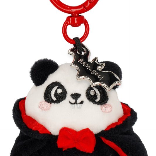 Close-up of embroidered panda face, bow tie, and bat charm
