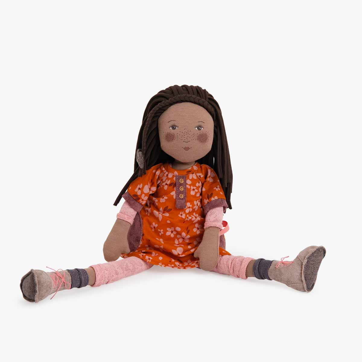 Front view of Camelia doll in orange floral dress with purple patches and lace tights