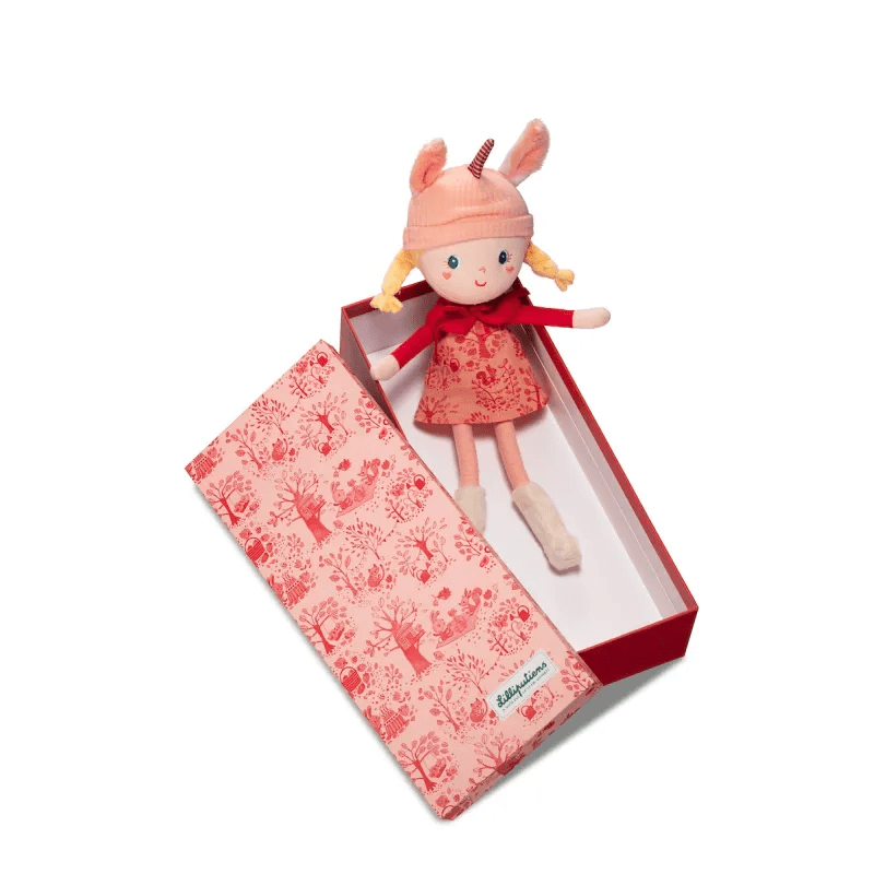 Lena fabric doll in pink corduroy hat with bunny ears and striped horn inside gift box