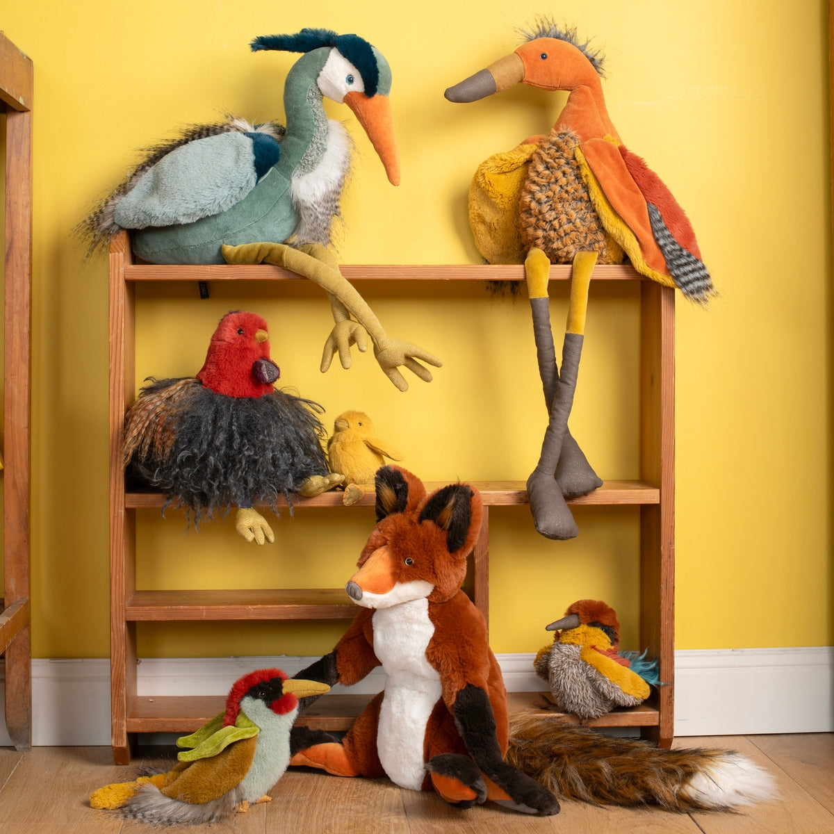 Moulin Roty plush chick and bird collection on wooden shelf