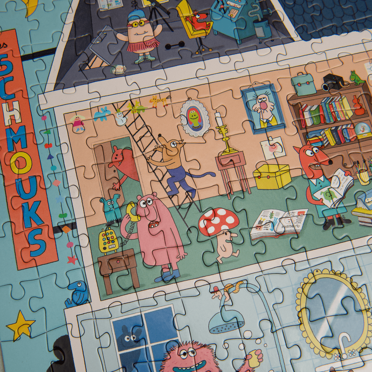 Close-up of interlocking edges in the 500-piece Les Schmouks puzzle showing colorful cartoon monsters