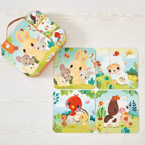 Open hexagonal JANOD metal tin displaying 4-piece farm animal jigsaw puzzles on wood surface