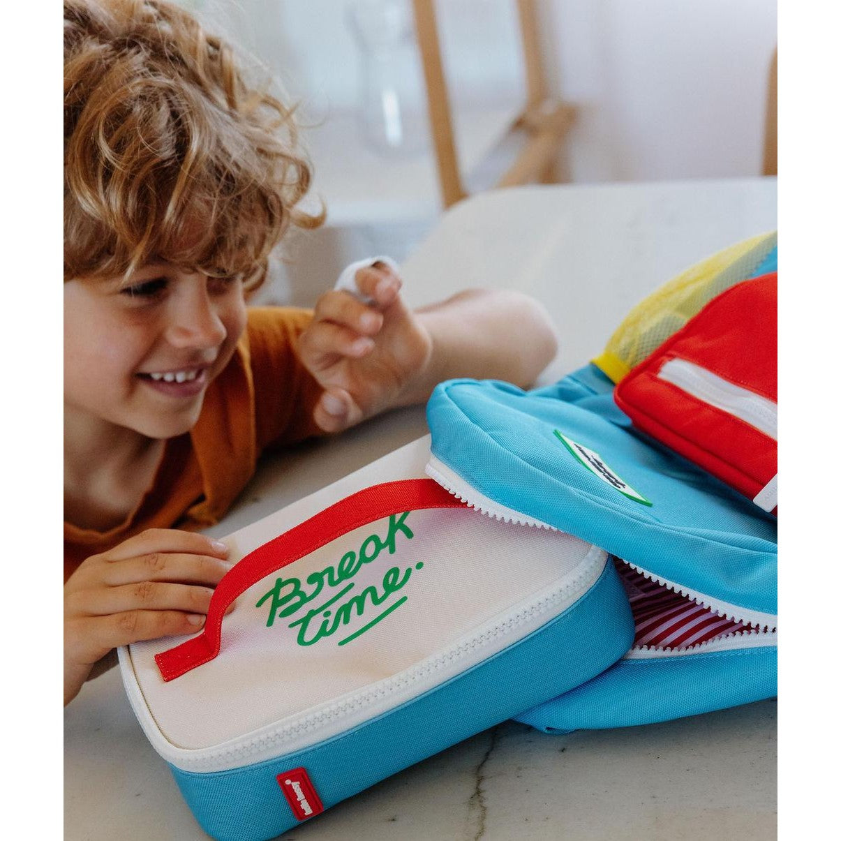 Collection of colorful children's insulated lunch bags on display