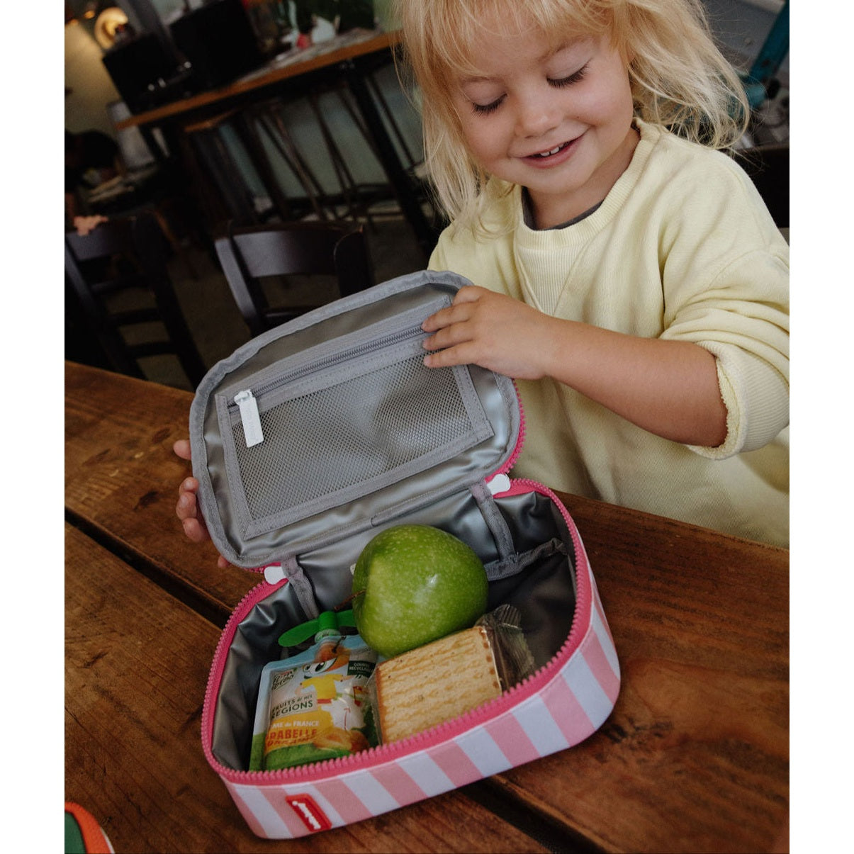 Open insulated lunch bag showing silver lining and mesh pocket