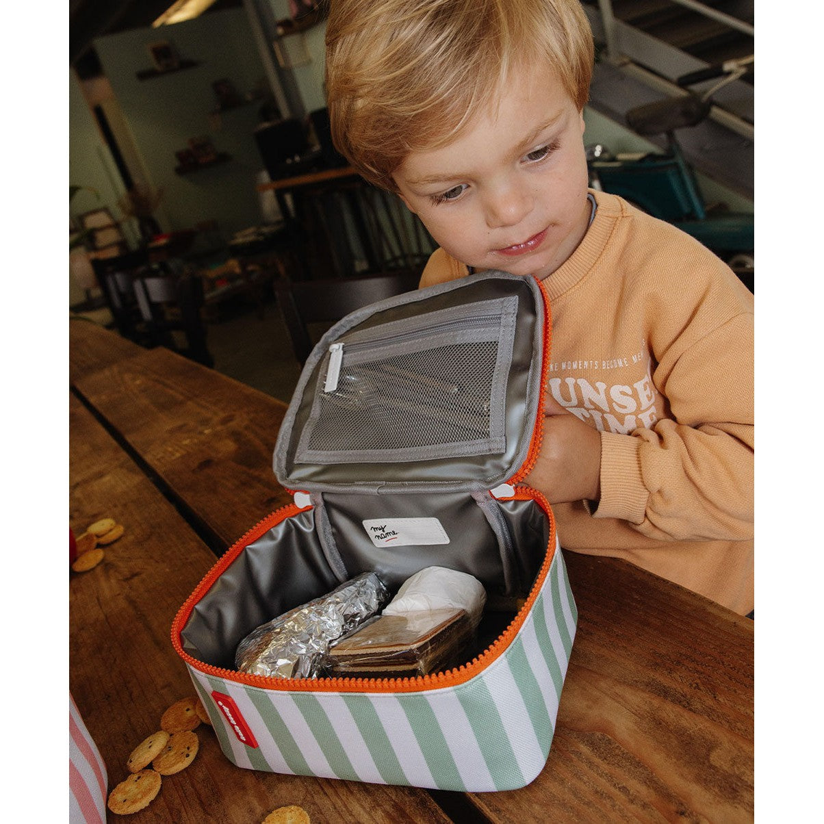Open insulated lunch bag interior with mesh pocket and name tag