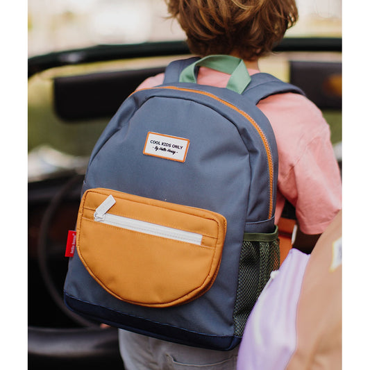 Kids standing with blue-gray backpack displaying green mesh pocket and orange details