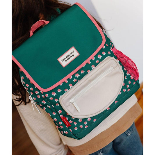Child wearing green floral square school backpack showing comfortable fit