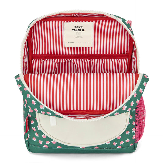 Interior of green floral kids backpack with striped lining and name tag pocket
