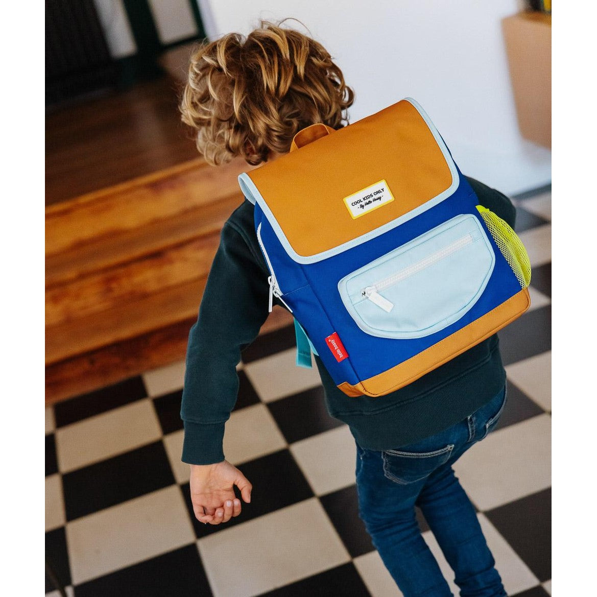 Child wearing color-block blue and orange mini backpack