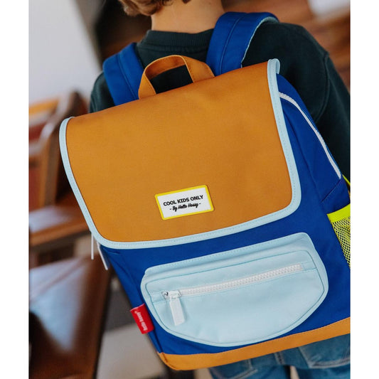 Child wearing blue and tan Hello Hossy school backpack