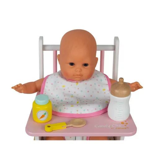 Doll in high chair wearing polka dot bib with feeding accessories