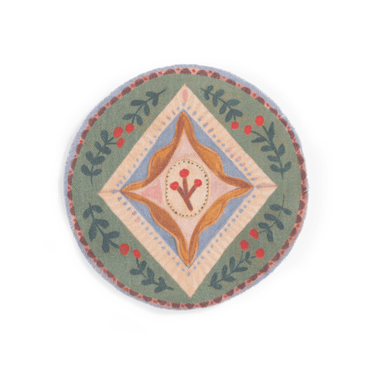 Close-up of circular folk-art fabric rug with berry pattern and frayed edges