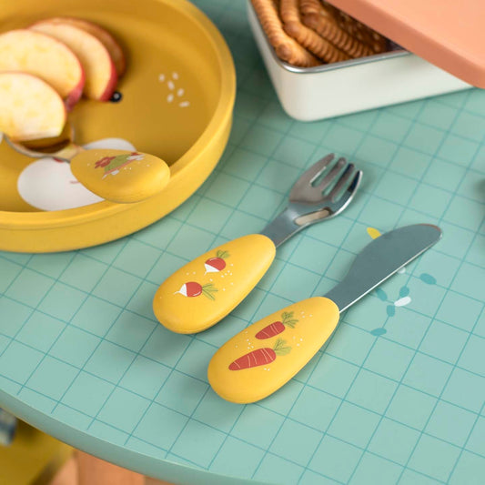 Children's stainless steel and silicone cutlery set with vegetable illustrations on table