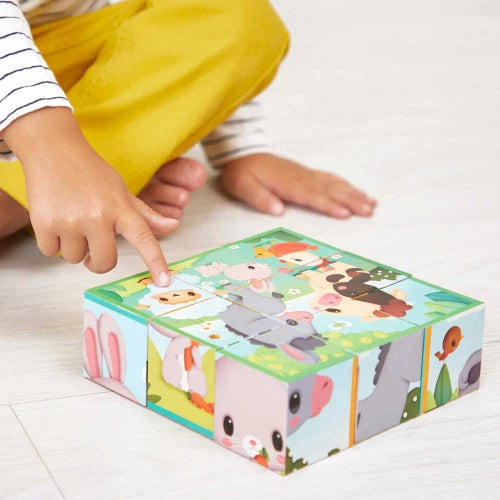 Toddler assembling JANOD cardboard farm animal cube toy