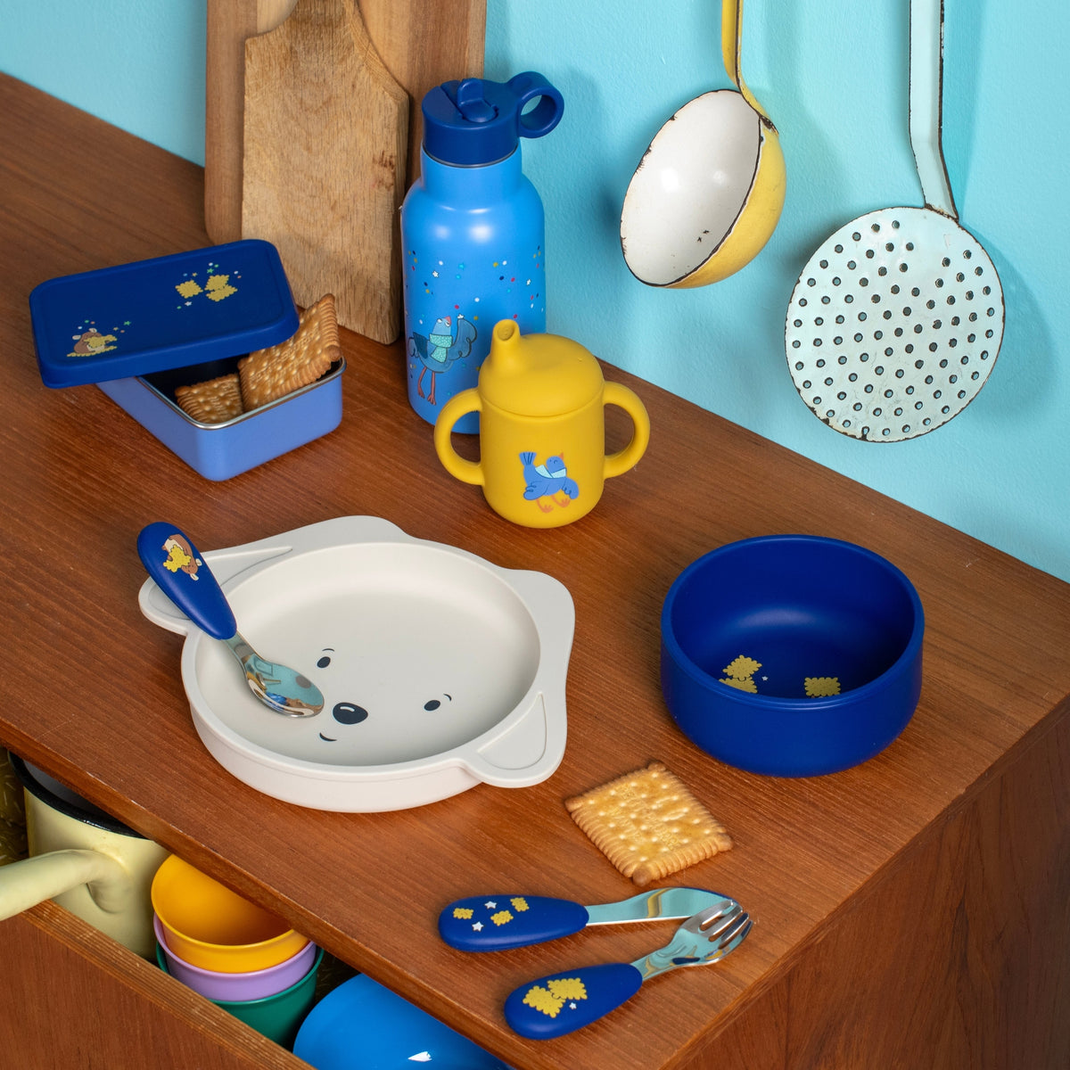 Puce & Pilou silicone tableware set on wooden table with spoon and crackers