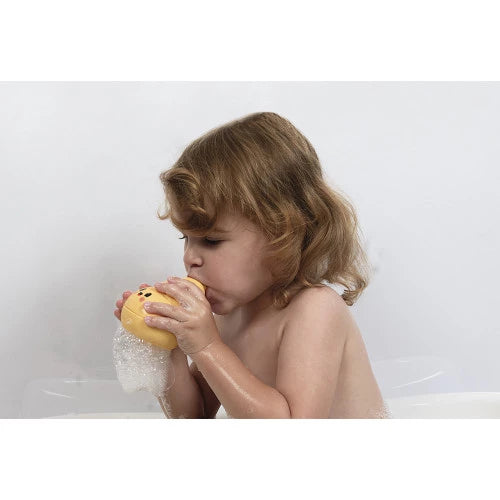 Toddler using yellow spiral bubble blower in bathtub