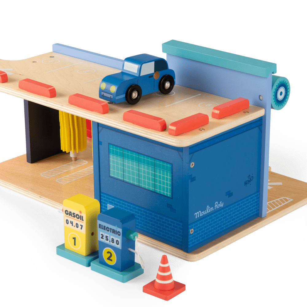 Top track detail of wooden toy car on Moulin Roty service station with pumps