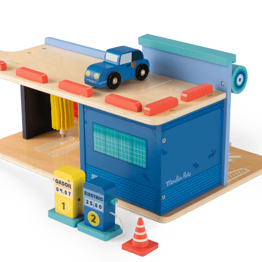 Top track detail of wooden toy car on Moulin Roty service station with pumps
