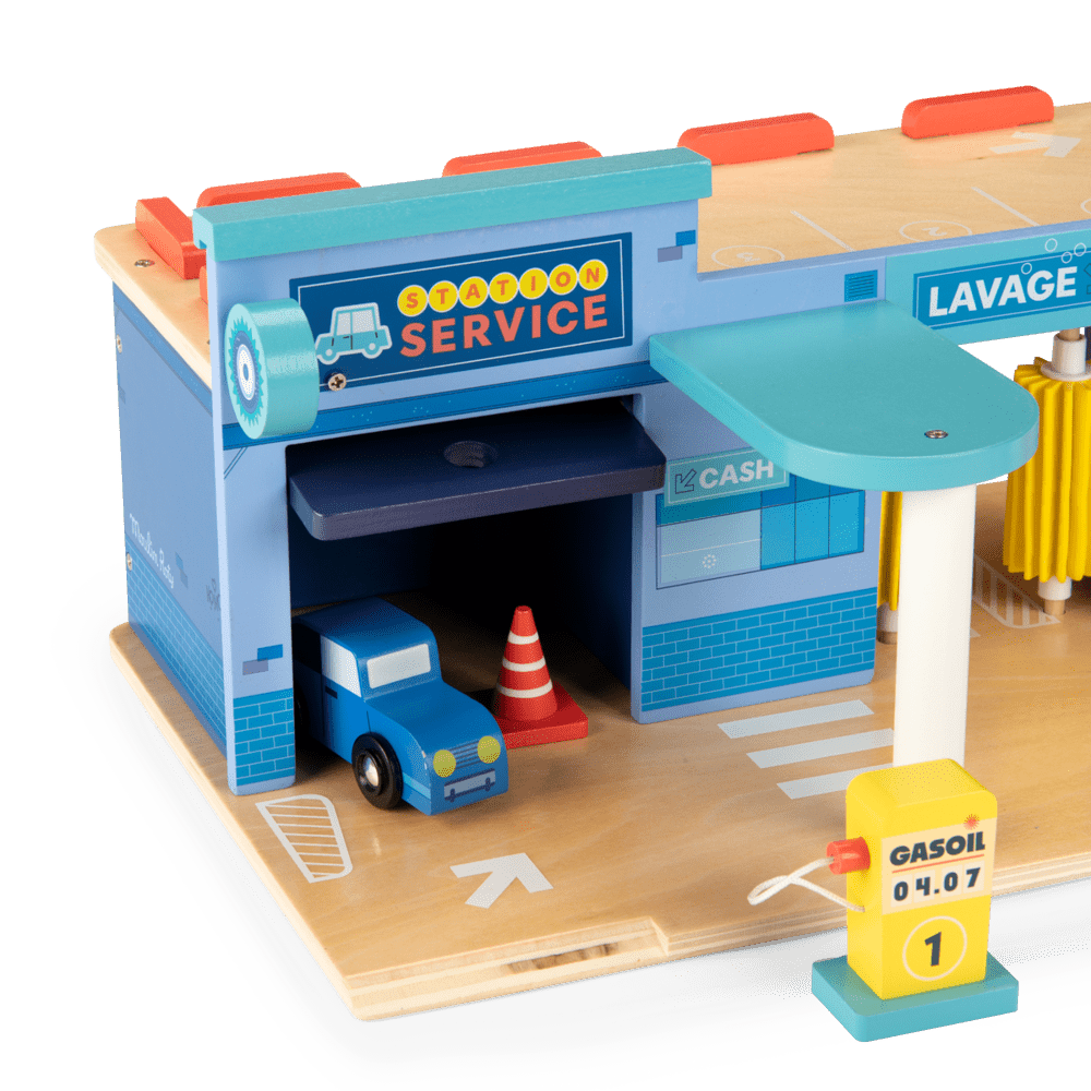 Close-up of blue wooden garage with car and yellow fuel pump at Moulin Roty station