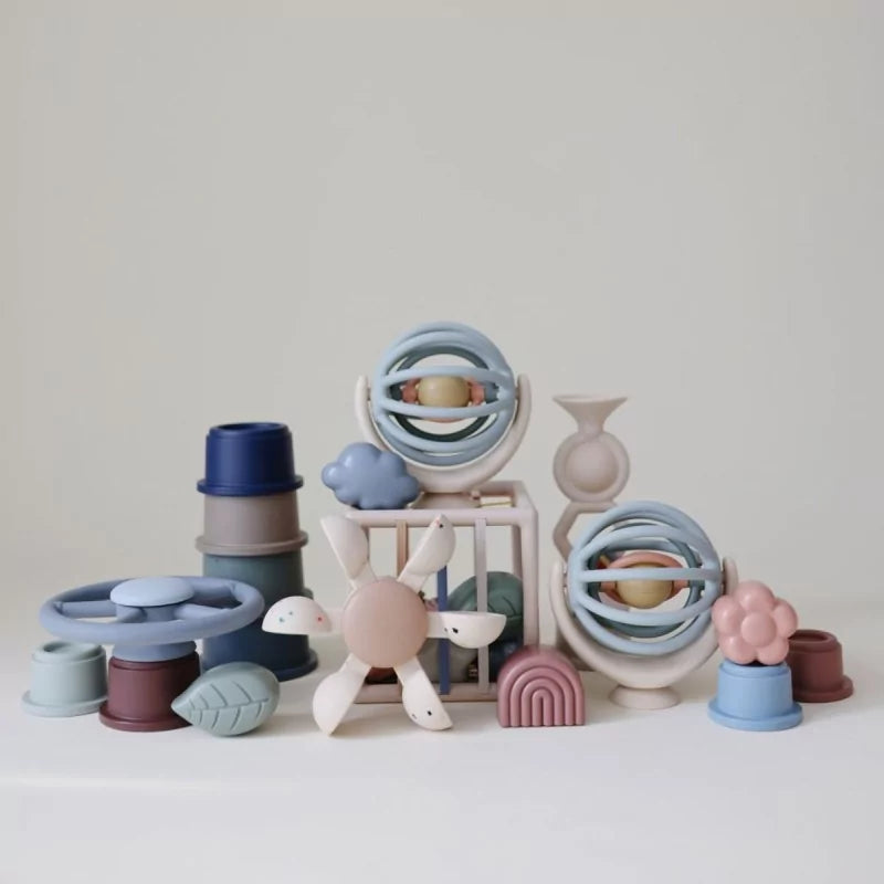 Collection of La Mushie silicone baby toys including Suction Spinner Ball