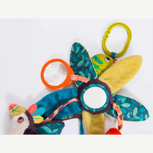 Top-down view of flower-shaped baby mobile with central reflective mirror