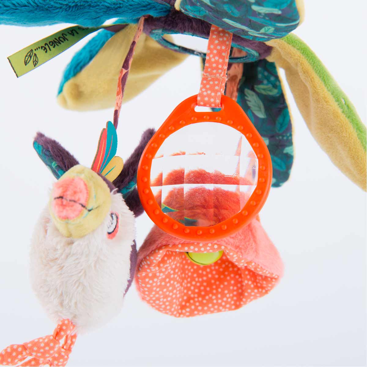 Detail view of crinkle prism mirror and jingle bell inside pink spotted flower