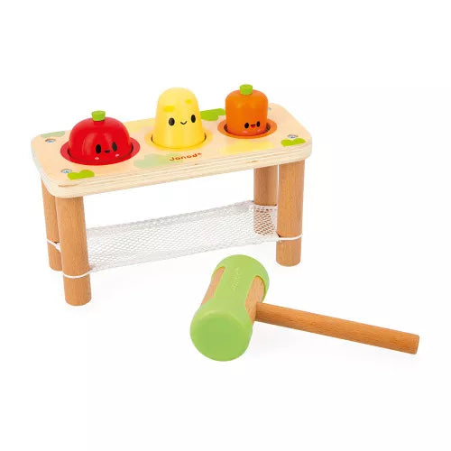 Top view of Janod wooden vegetable hammering toy with mesh netting and green mallet